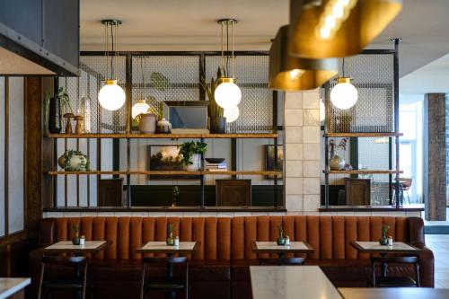 a restaurant with tables and chairs and lights at Hilton Garden Inn Wausau, WI in Wausau