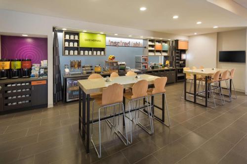 a restaurant with tables and chairs in a store at Home2 Suites By Hilton Mishawaka South Bend in Mishawaka