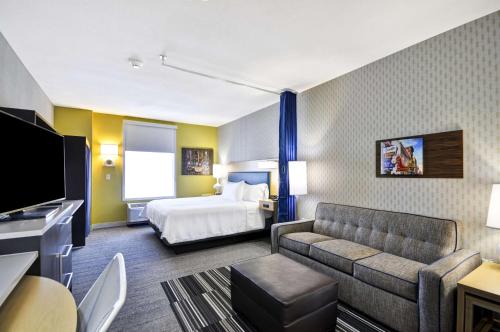 a hotel room with a bed and a couch at Home2 Suites By Hilton Mt. Juliet, Tn in Mount Juliet