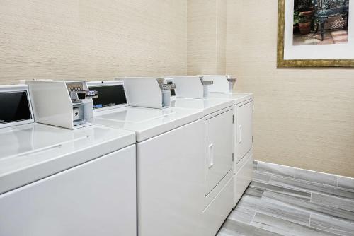 a row of white washing machines in a room at Hilton Garden Inn San Marcos in San Marcos