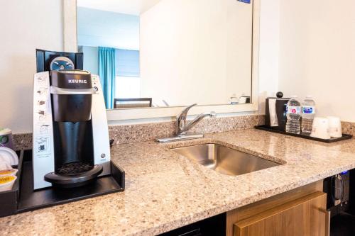 a kitchen with a sink and a coffee maker on a counter at Hilton Garden Inn Asheville Downtown in Asheville