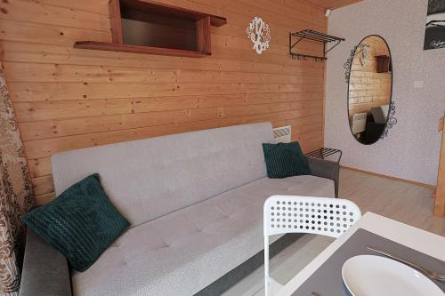 a living room with a couch and a mirror at Aurora Ustka in Ustka