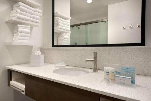 a bathroom with a sink and a mirror and towels at Hampton Inn by Hilton Spring Hill, TN in Kedron