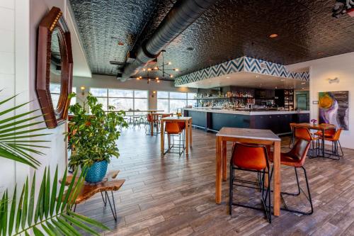 a restaurant with tables and chairs and a bar at Hilton Garden Inn Asheville Downtown in Asheville