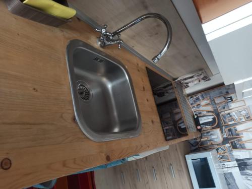 a sink attached to the wall of a kitchen at Appartamento Nonna Lina in Padenghe sul Garda