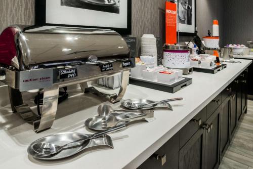 a kitchen with stainless steel utensils on a counter at Hampton Inn & Suites Wixom/Novi/Detroit, Mi in Wixom