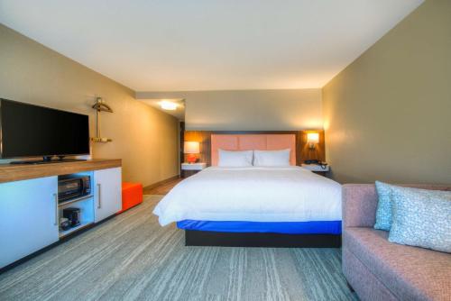 a hotel room with a bed and a couch at Hampton Inn & Suites Wixom/Novi/Detroit, Mi in Wixom