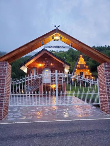 a church with a white gate in front of it at Vilat Pllumaj in Gropat e Selcës
