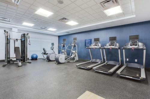 a gym with several treadmills and machines in a room at Hampton Inn and Suites Jacksonville/Orange Park, FL in Orange Park