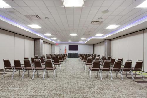 an empty room with chairs and a projection screen at Hampton Inn and Suites Jacksonville/Orange Park, FL in Orange Park