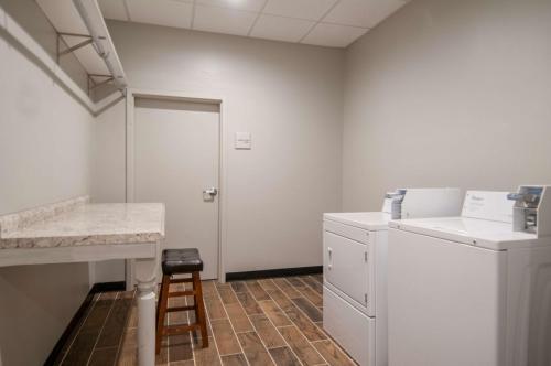 a laundry room with a counter and a stool at Hampton Inn Opelousas in Opelousas