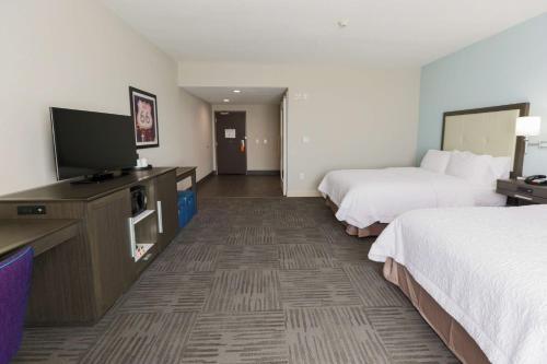 a hotel room with two beds and a flat screen tv at Hampton Inn El Reno Ok in El Reno