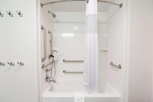 a white bathroom with a shower and a sink at Hampton Inn El Reno Ok in El Reno