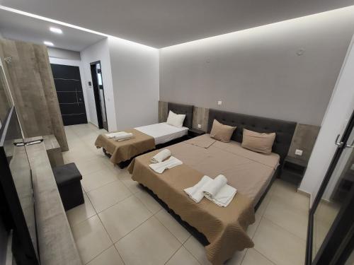 a bedroom with two beds with towels on them at RADINA FAMILY in Kallithea Halkidikis