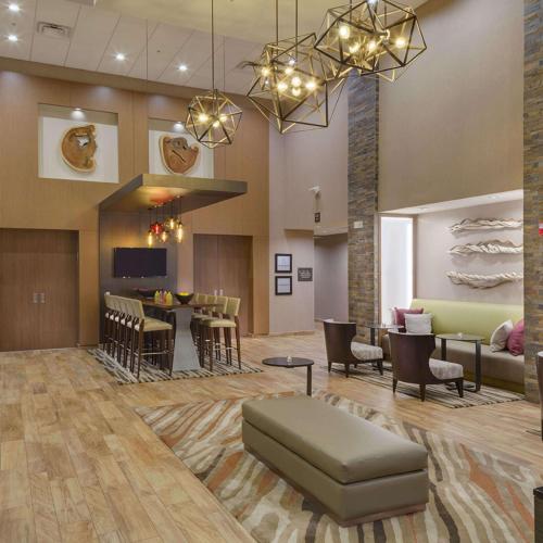 a lobby with a waiting area with a couch and chairs at Hampton Inn & Suites Murrieta Temecula in Murrieta