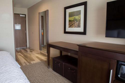 a hotel room with a desk and a television at Hampton Inn & Suites Murrieta Temecula in Murrieta