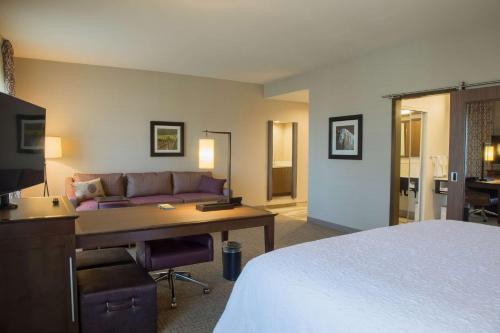 a hotel room with a bed and a desk and a couch at Hampton Inn & Suites Murrieta Temecula in Murrieta