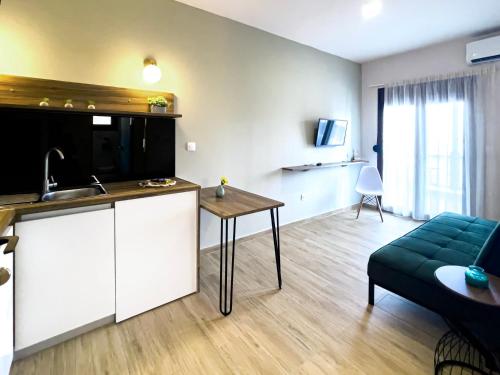 a kitchen and living room with a couch and a table at ATHONITE all seasons luxury suites in Ierissos