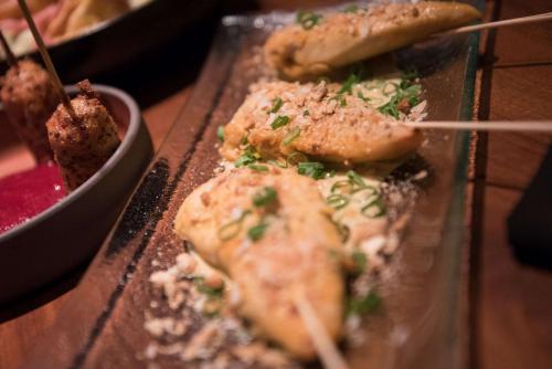 a tray of food on a table with chop sticks at The Desmond Hotel Malvern, a DoubleTree by Hilton in Malvern