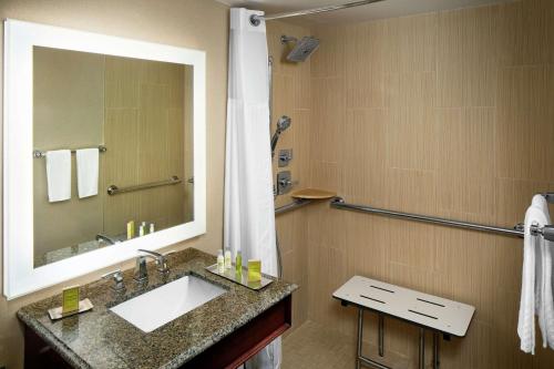 a bathroom with a sink and a mirror at The Desmond Hotel Malvern, a DoubleTree by Hilton in Malvern