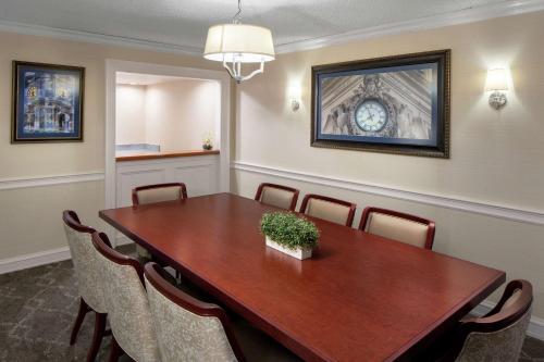 a conference room with a wooden table and chairs at The Desmond Hotel Malvern, a DoubleTree by Hilton in Malvern