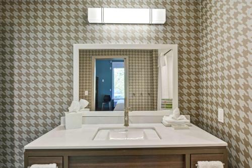 a bathroom with a sink and a mirror at Home2 Suites By Hilton Dayton Vandalia in Dayton