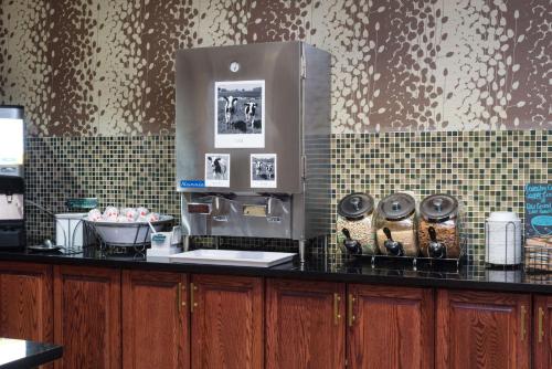 a kitchen with a counter with a coffee machine at Hampton Inn & Suites Wilson I-95 in Wilson