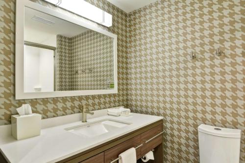 a bathroom with a sink and a mirror at Home2 Suites By Hilton Dayton Vandalia in Dayton