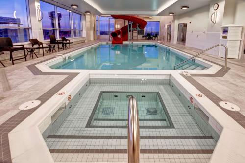 a large swimming pool in the middle of a building at Hampton Inn & Suites by Hilton Grande Prairie in Grande Prairie