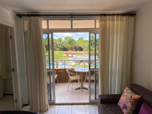 a living room with a sliding glass door to a patio at GRAN FLAT LENCOIS/ BARREIRINHAS - 201C in Barreirinhas