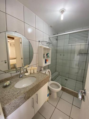 a bathroom with a sink and a toilet and a mirror at GRAN FLAT LENCOIS/ BARREIRINHAS - 201C in Barreirinhas