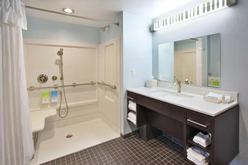 a bathroom with a sink and a shower and a mirror at Home2 Suites By Hilton Pittsburgh Area Beaver Valley in Monaca