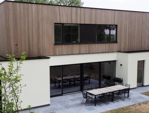 a building with a picnic table on a patio at Fluithoekhoeve in Koksijde