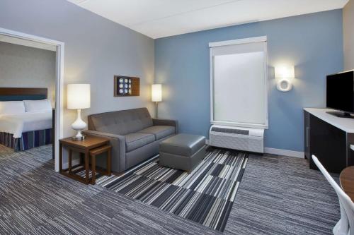 a hotel room with a couch and a bed at Home2 Suites By Hilton Pittsburgh Area Beaver Valley in Monaca