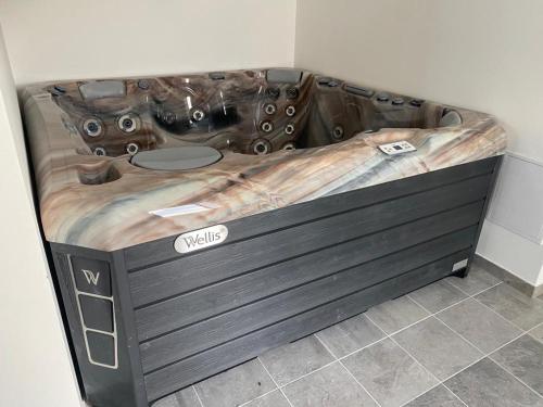 a large wooden bed in a corner of a room at N&H Pansion in Mostová