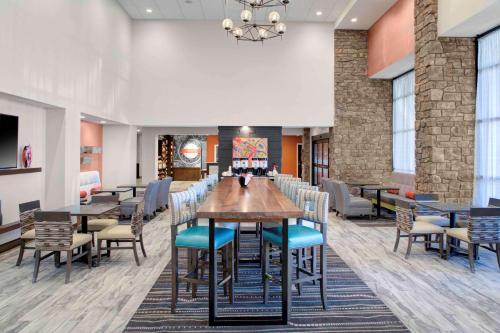 a dining room with a long table and chairs at Hampton Inn Suites Flagstaff East in Flagstaff