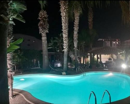 a swimming pool at a resort at night at B&B Villa Colomba in Agrigento