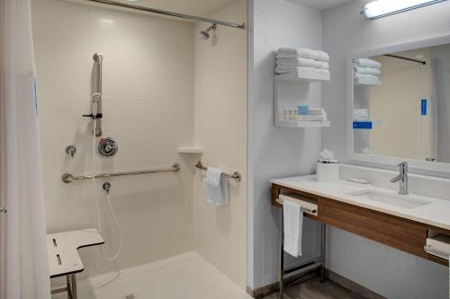 a white bathroom with a sink and a shower at Hampton Inn Suites Flagstaff East in Flagstaff