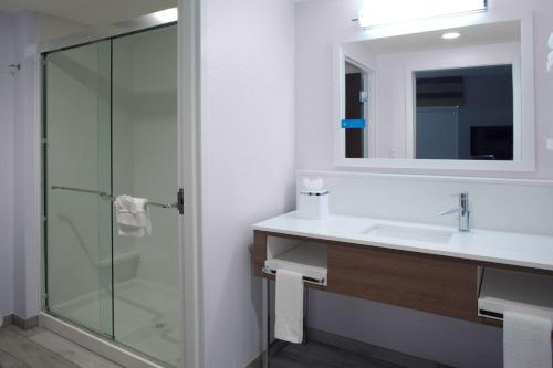 a bathroom with a sink and a glass shower at Hampton Inn Suites Flagstaff East in Flagstaff