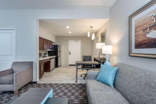 a living room with a couch and a table at Homewood Suites By Hilton Fayetteville in Fayetteville