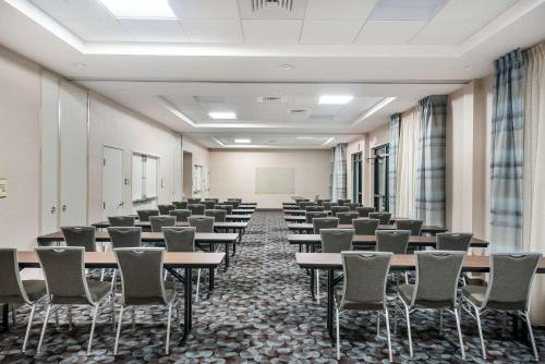 an empty room with rows of tables and chairs at Homewood Suites By Hilton Fayetteville in Fayetteville