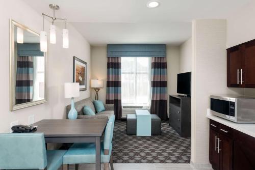 a living room with a dining table and a living room at Homewood Suites By Hilton Fayetteville in Fayetteville