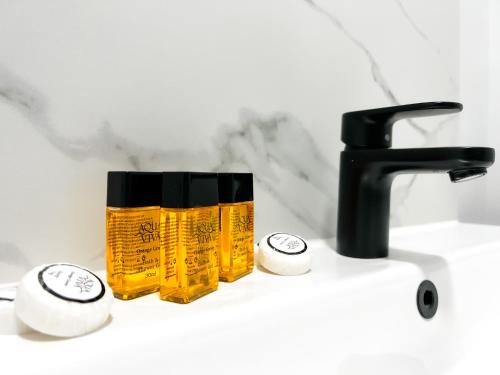 a yellow mug sitting on a sink next to a faucet at Argo Hotel - Kings Cross in London