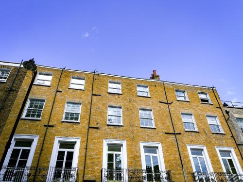 a large red brick building with white windows at Argo Hotel - Kings Cross in London