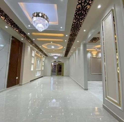 a hallway in a building with a chandelier at elite department in Kafr al Muşayliḩah