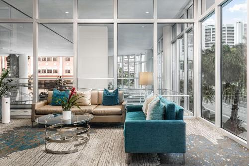 a living room with a couch and a table at Embassy Suites By Hilton Sarasota in Sarasota