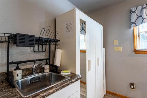 a kitchen with a sink and a counter top at Sea Cave, OBX gem, private studio, couple's nest! in Kill Devil Hills