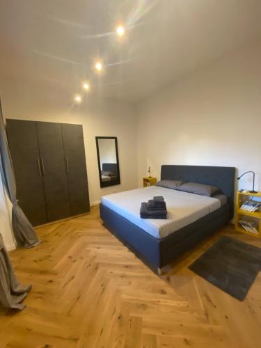 a bedroom with a large bed and a wooden floor at sonnino house in Pisa