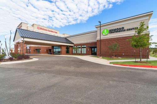 a store front of a building with a parking lot at Hilton Garden Inn Edmond/Oklahoma City North in Edmond
