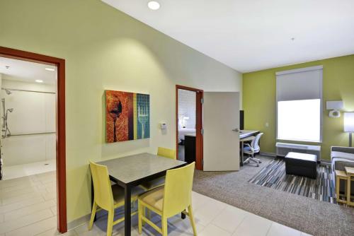 a dining room with a table and yellow chairs at Home2 Suites by Hilton Brownsville in Brownsville